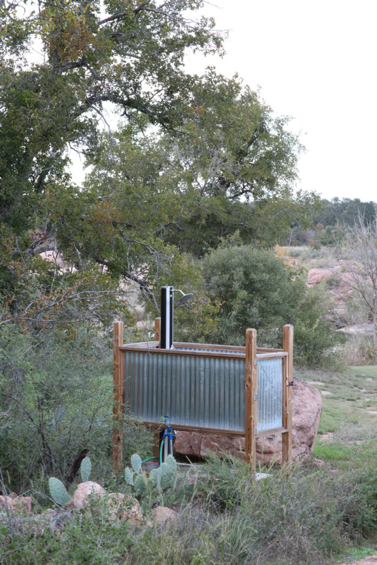 An open-air shower set amid the Texas brush.