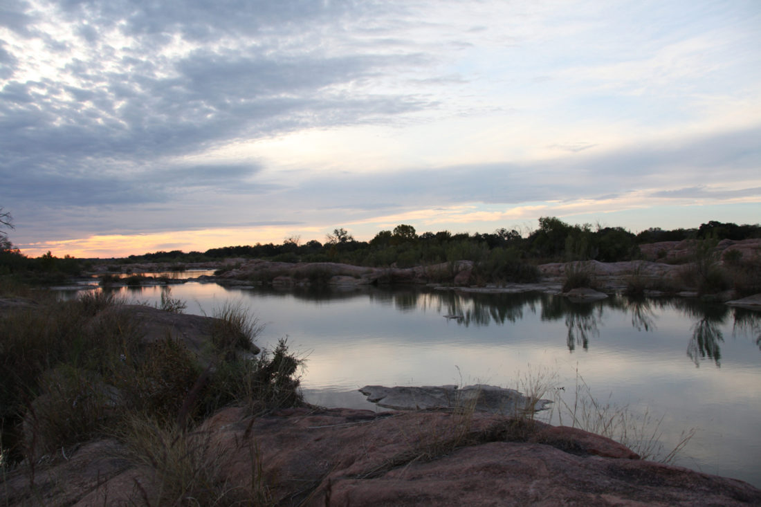 Night settles on a sweeping view of the Llano River.