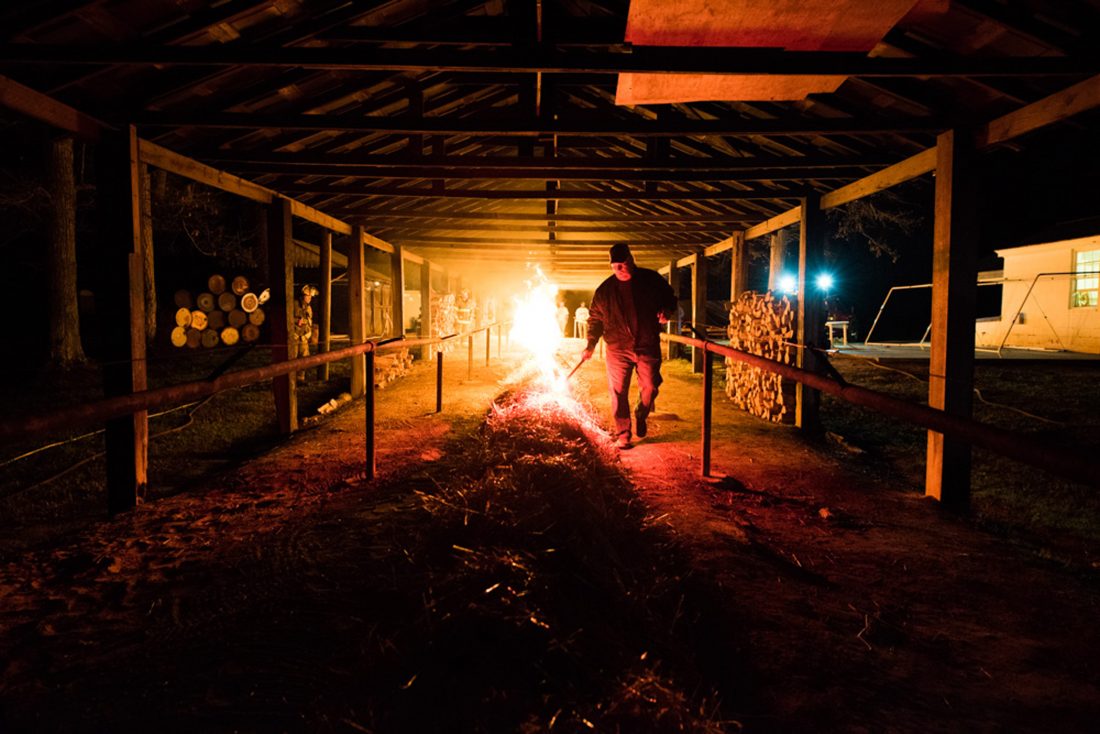 Tending to the fire.