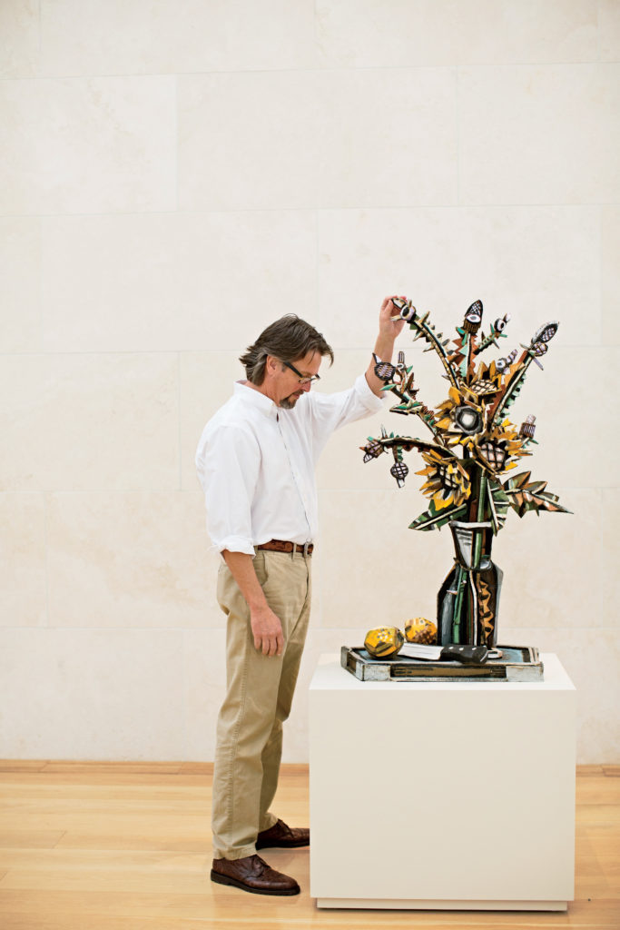 Bates inspects his Sunflowers and Thistles Still Life I, 1998–1999, at the Nasher Sculpture Center.