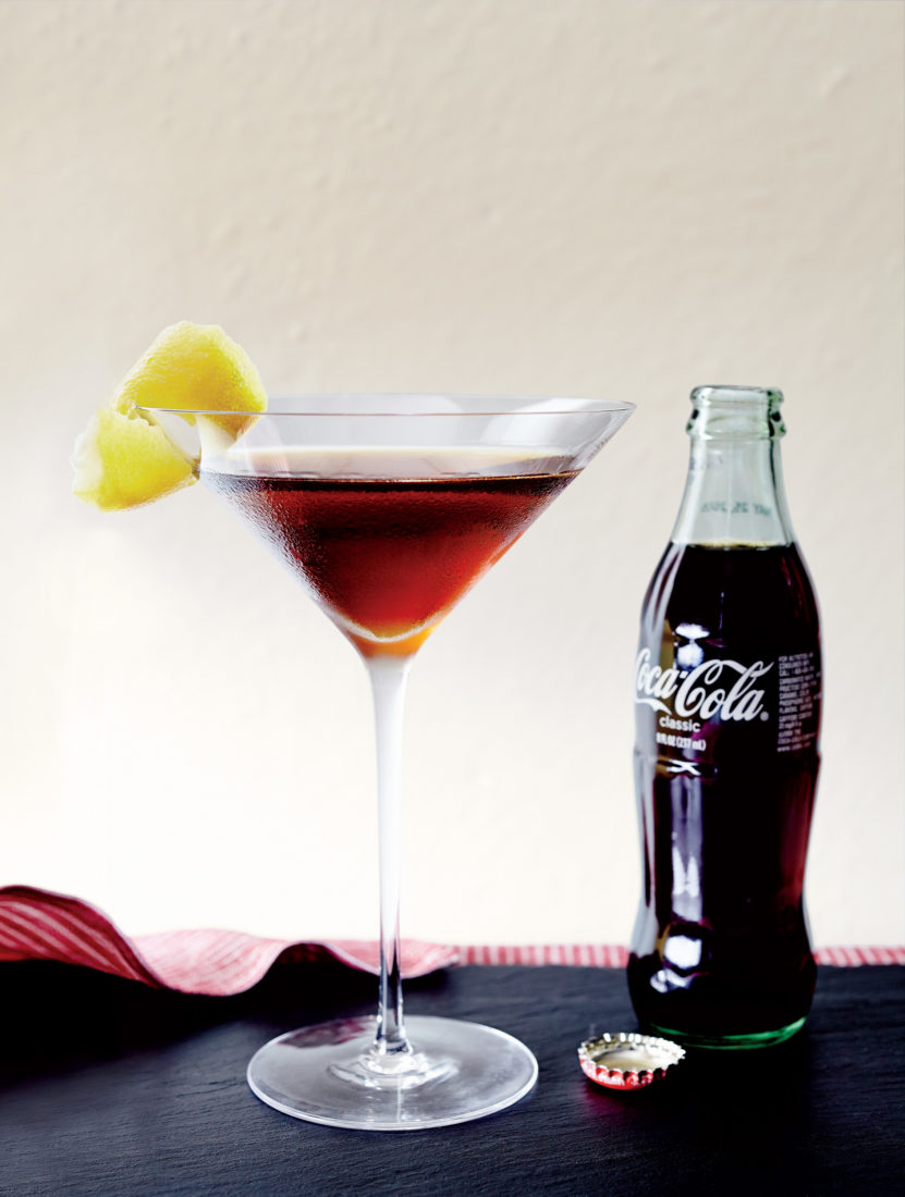 Bourbon & Coke
This “reengineered” version of the classic Southern concoction upgrades it from highball to cocktail by making a Coca-Cola syrup that just lightly flavors a shot of bourbon, the cola sweetness tempered by dashes of Angostura bitters and a swipe of lemon peel.
>Get the Recipe