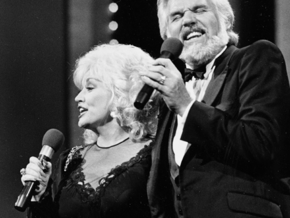 Dolly Parton and a man singing