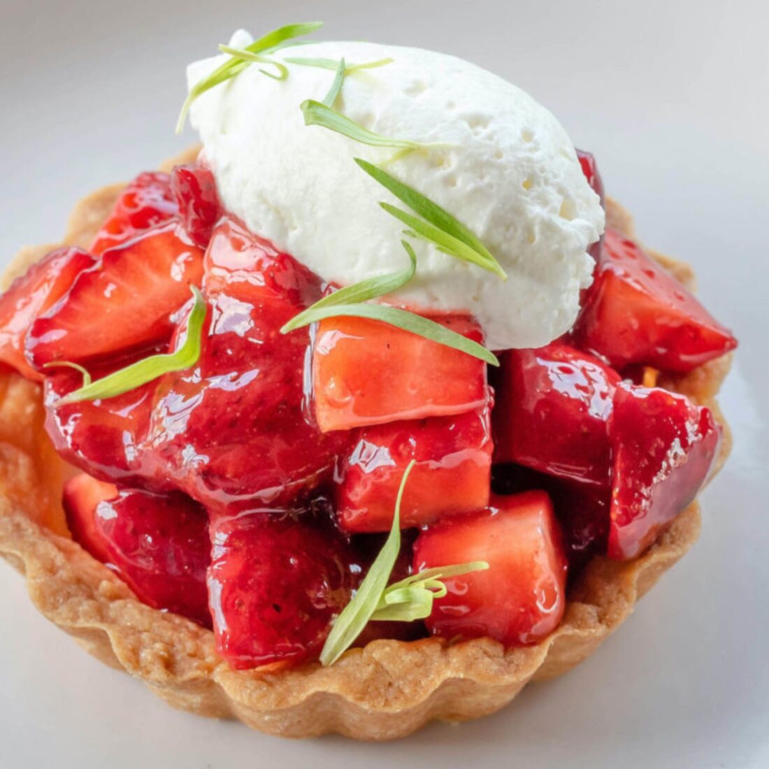 Sara Bradley’s Strawberry Basil Pie with Black Pepper Whipped Cream
The Kentucky chef’s favorite childhood dessert plays up sweet spring strawberries.
Get the recipe.