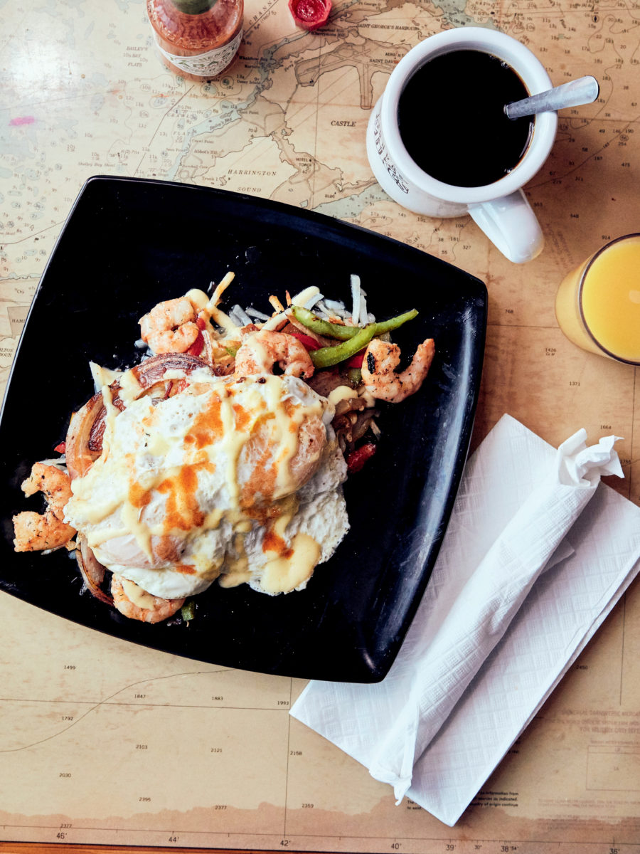 hash browns, with shrimp and eggs on a plate