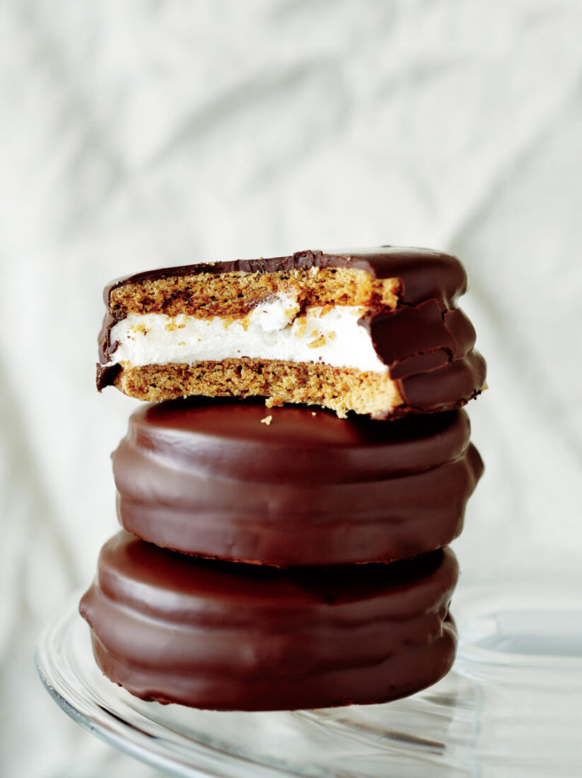 A marshmallow between two graham crackers, covered in chocolate.