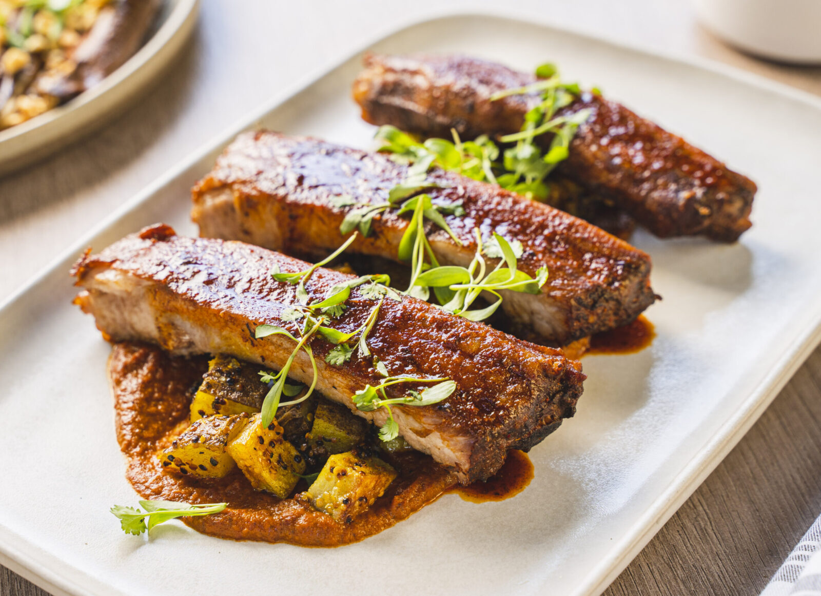Smoky Ribs with Makhani Sauce and Turmeric Potatoes – Garden & Gun
