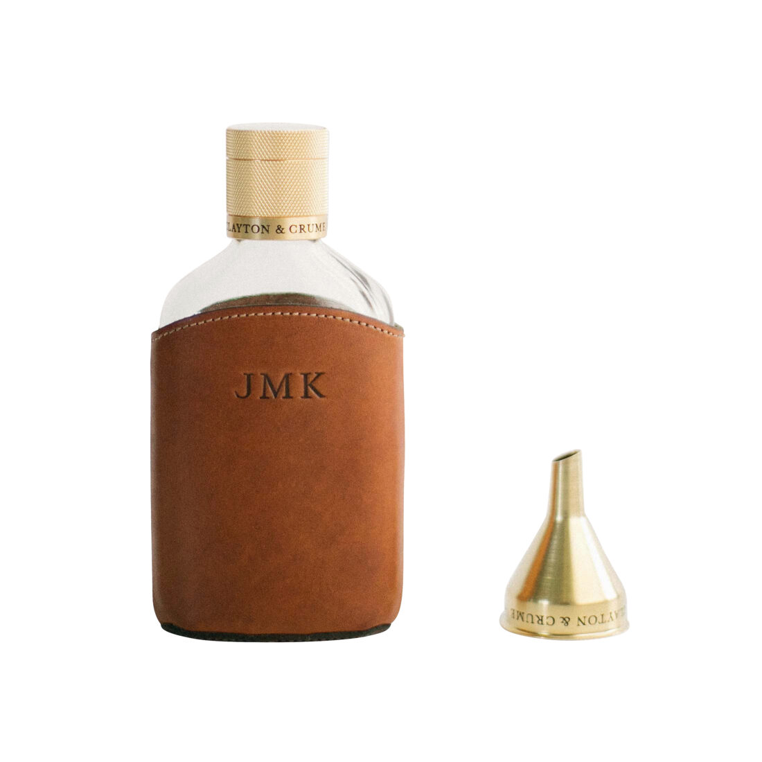 Description: Clayton & Crume English saddle leather-wrapped glass flask with solid brass cap and funnel, $125.