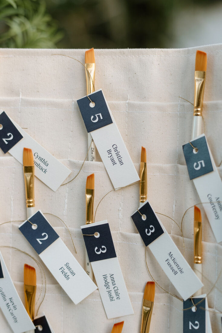 Guests’ table numbers displayed on paintbrushes.