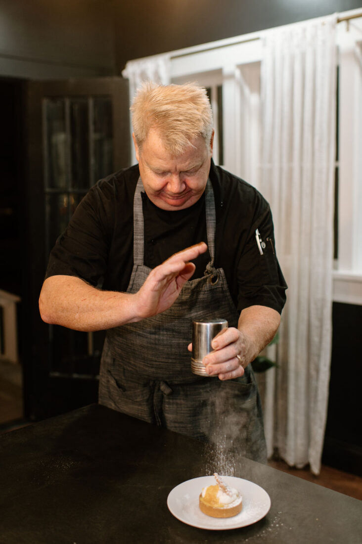 Chef Scott Krause plating the third course, an Indian River orange lime tart with citrus marmalade and chantilly cream.