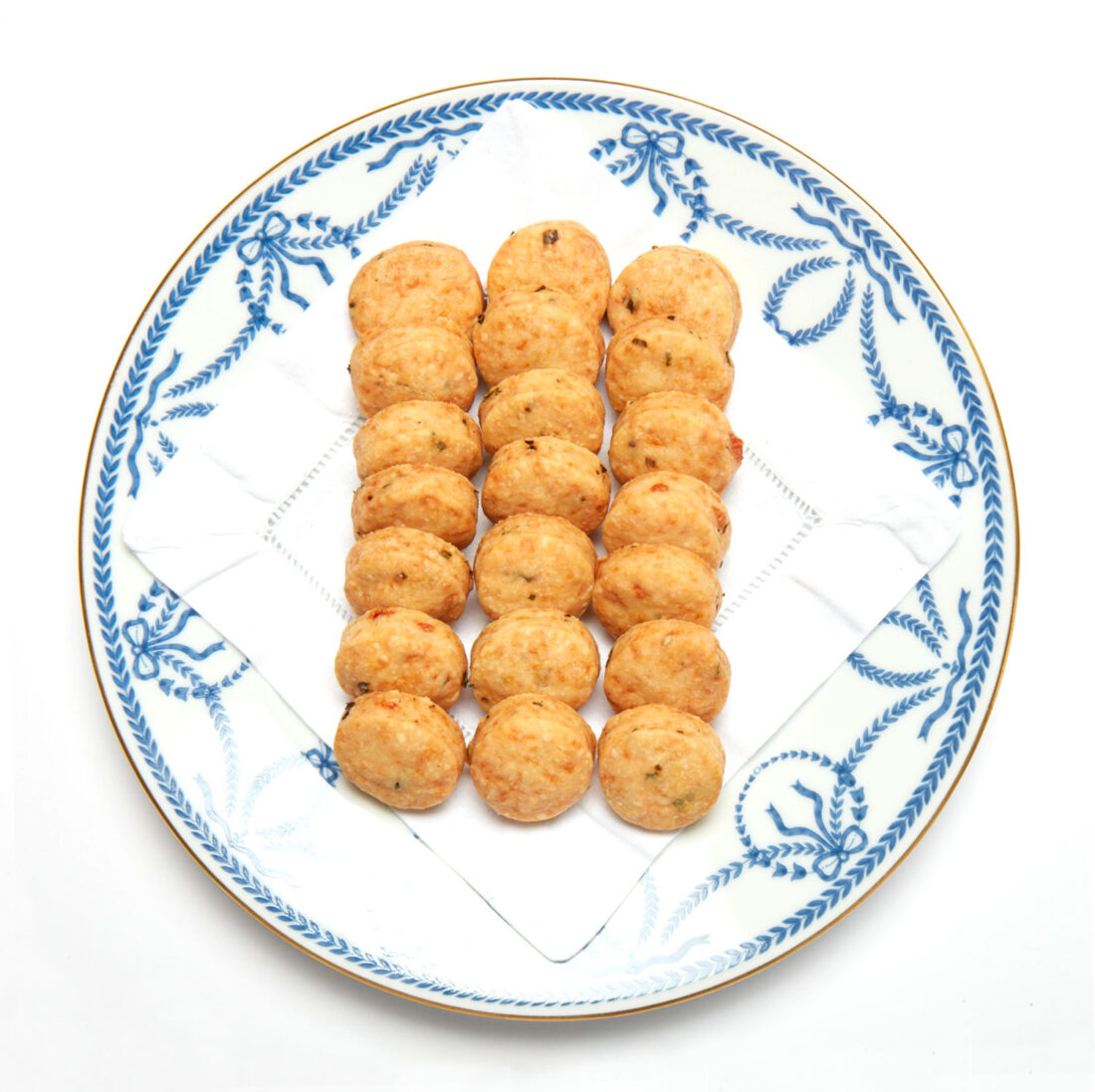 A blue and white patterned plate of cheddar wafers