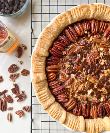 A pie with pecans on top and next to it