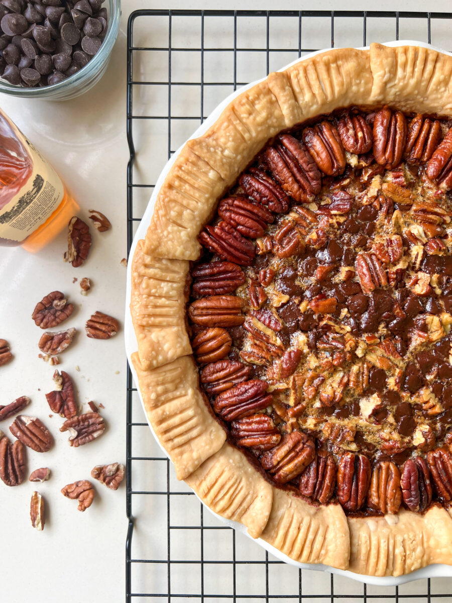 A pie with pecans on top and next to it
