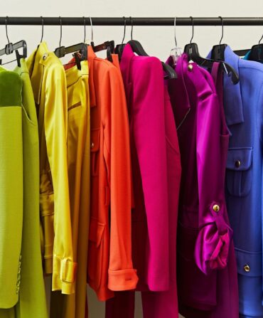 A rainbow of suits on a clothing rack