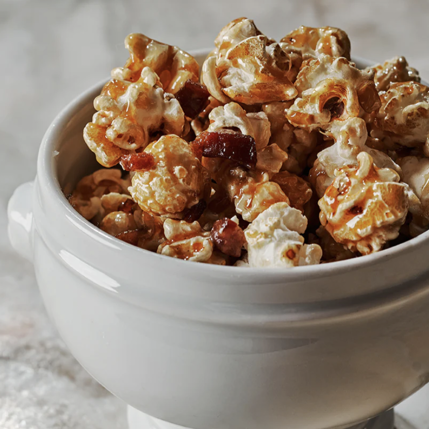 A white bowl with caramel popcorn inside