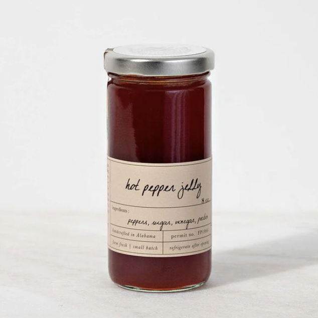 A jar of red jam with a silver lid