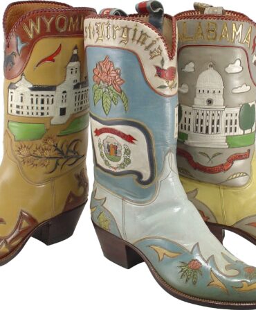 Three boots are laid of from the state collection: Wyoming (a brown boot with darker red details and the state capitol building), West Virginia (a blue boot with a pink flower, cardinal, and berries), and Alabama (a yellow and grey boot with the capitol building).