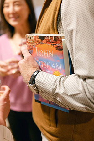 A person holds a copy of The Exchange