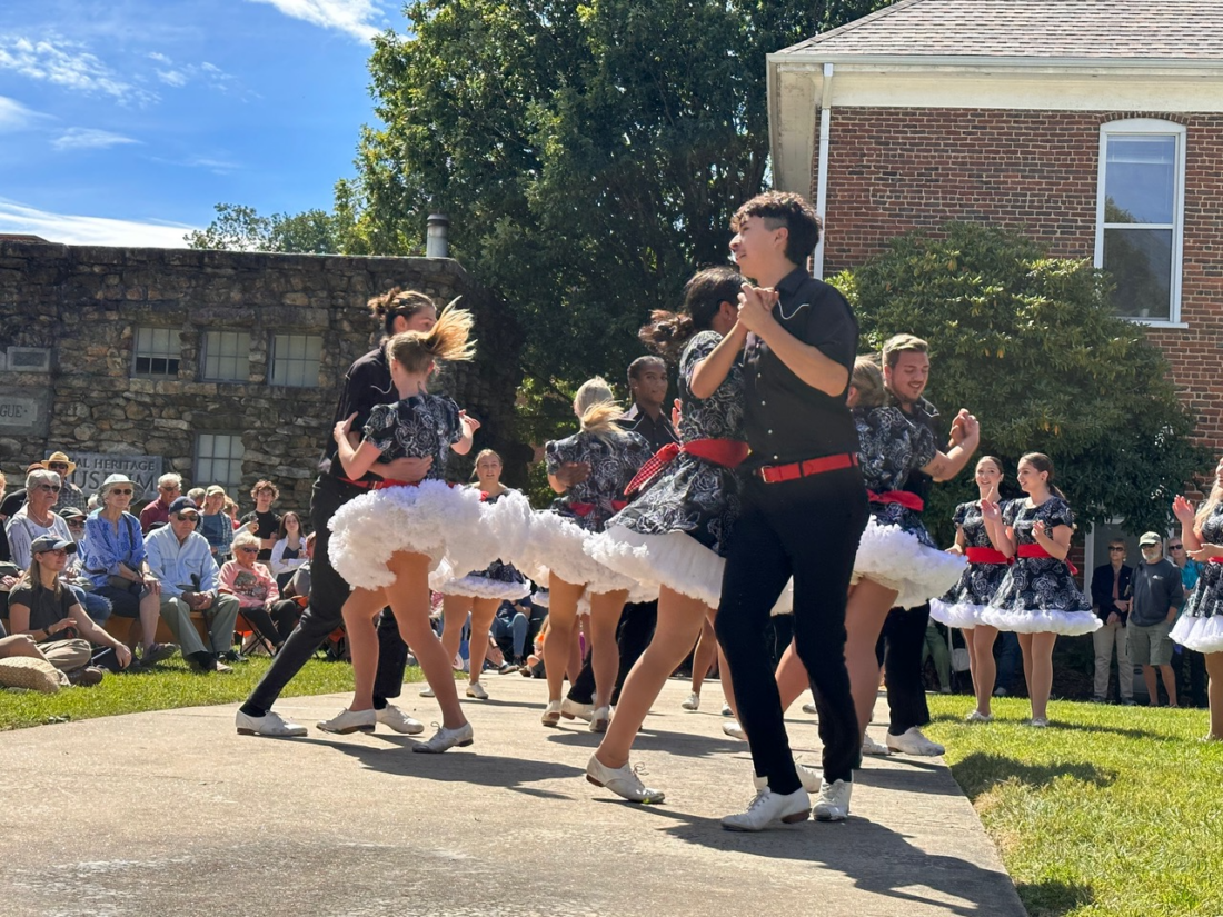 Cloggers perform a swing during a freestyle Appalachian hoedown.