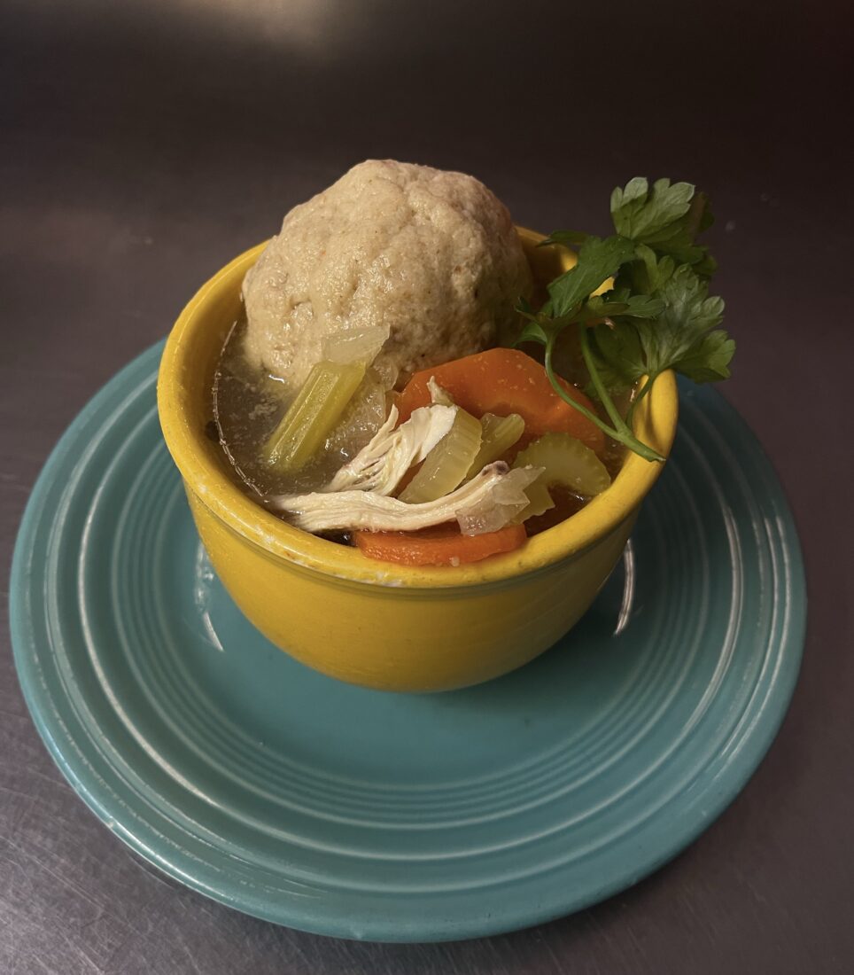 A bowl of soup with a matzo ball