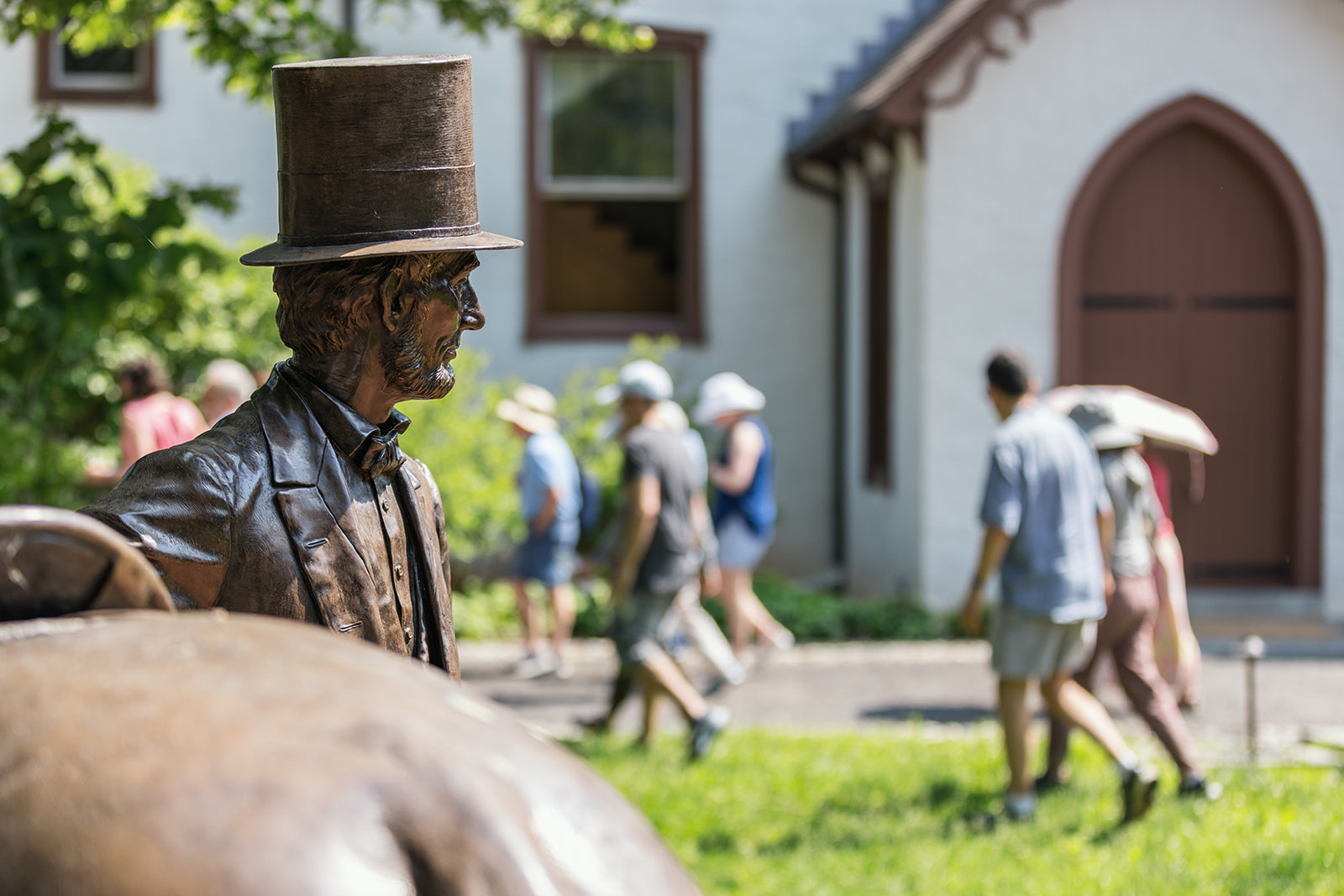 A close-up detail of a bronze statue of President Lincoln in front of the cottage.