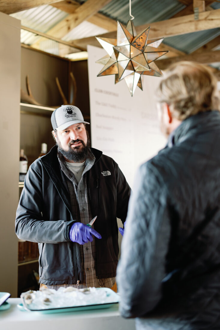 Nate Alton, Lowcountry Oyster Company sales director shucks oysters for happy hour.