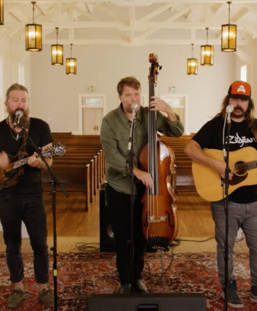 Five members of Greensky Bluegrass playing their instruments