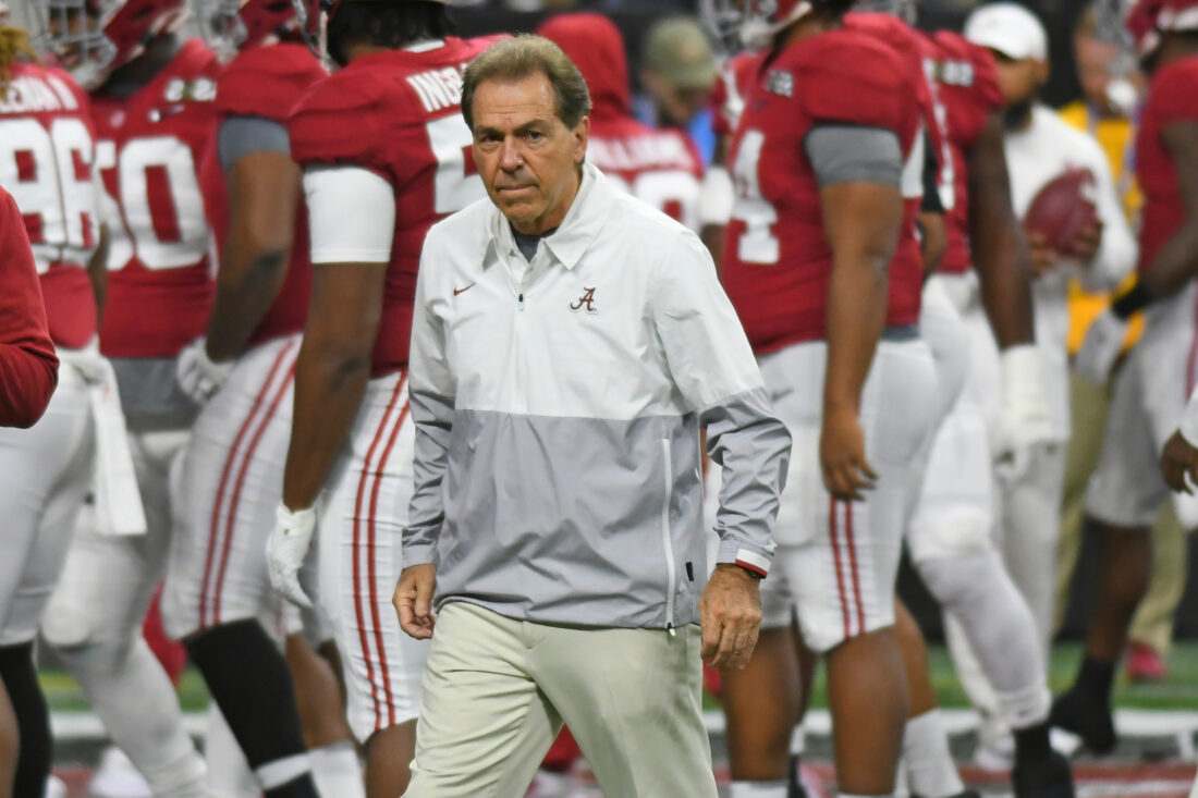 Nick Saban in front of a group of players