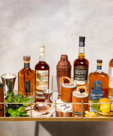 Bottles of bourbon and bar essentials to Stock the Bar