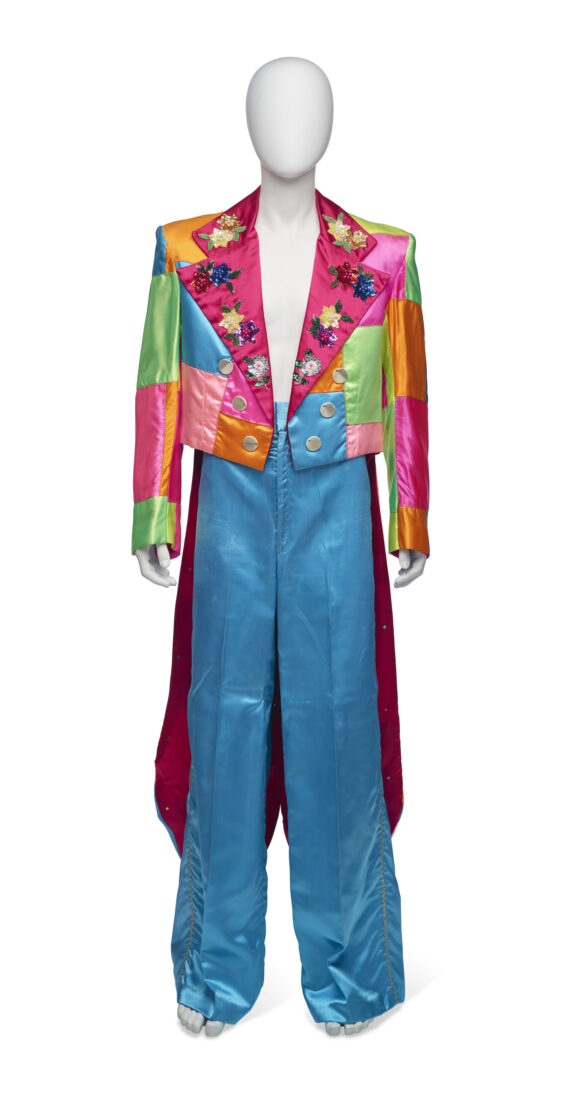 A blue, pink, and green satin stage costume with a cape