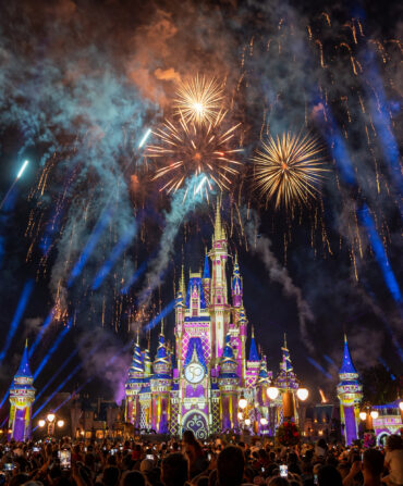 Fireworks light up a night sky over a castle in Disney World