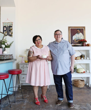 A man and woman stand in a bakery