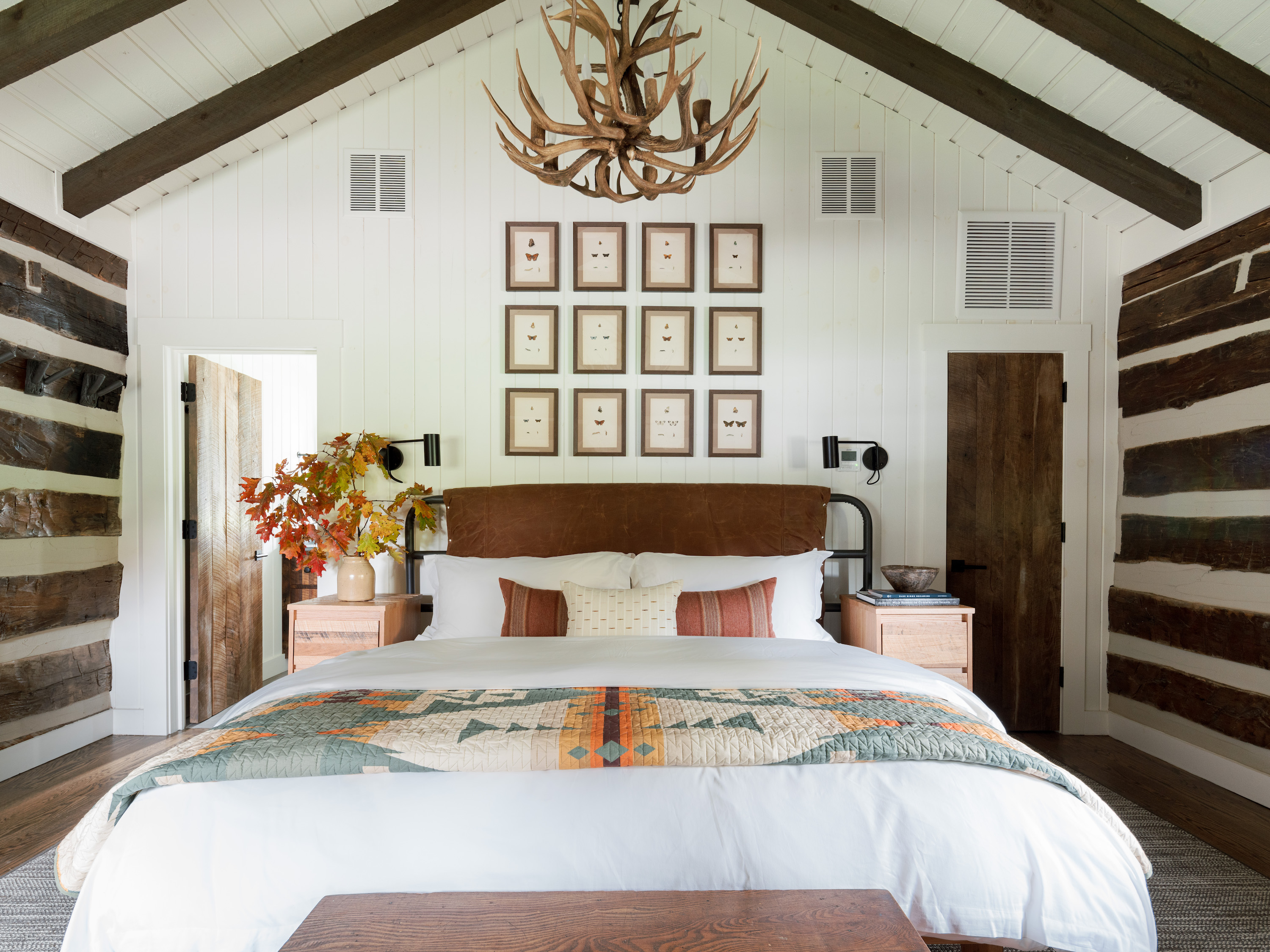 A guest room with wood details and framed butterfly illustrations