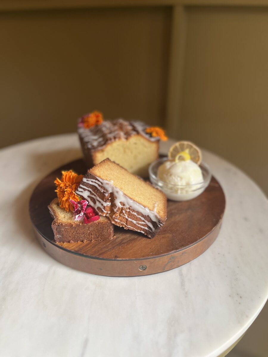 A plate of cake with icing and flowers