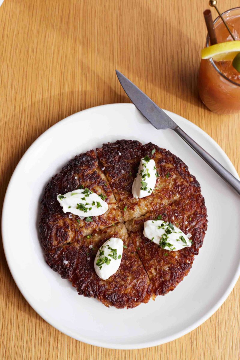 Ham cream on top of a hashbrown on a plate