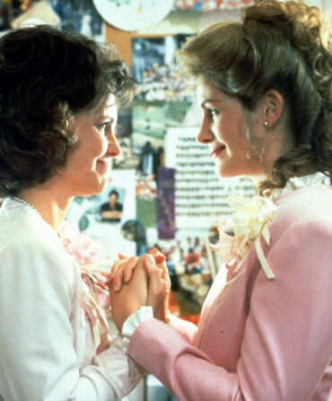 A still from Steel Magnolias of two women holding hands