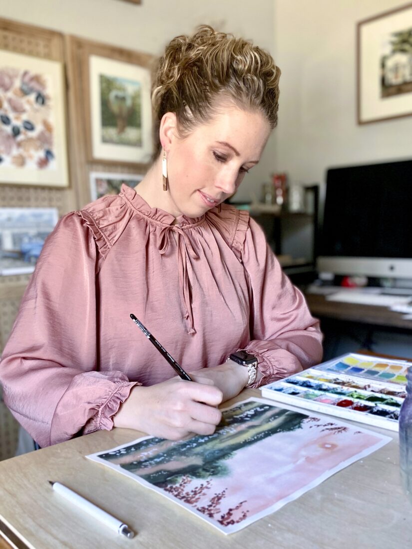 A portrait of a woman working on a watercolor painting