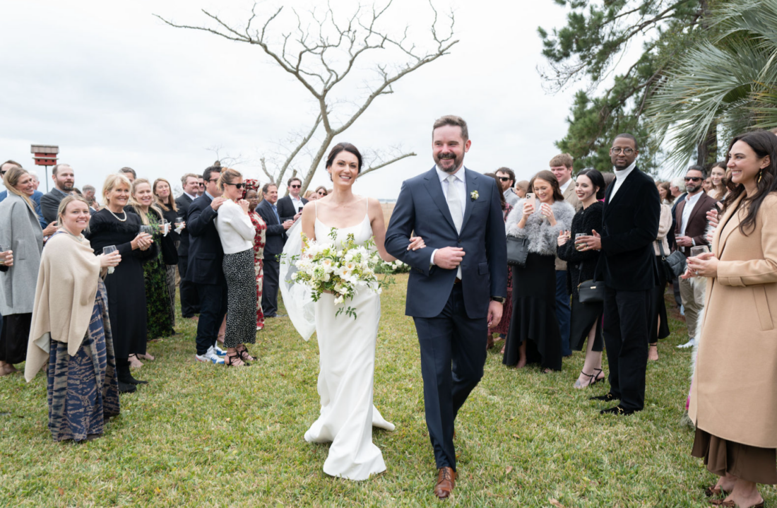 bride and groom walk down the aisle after their wedding ceremony