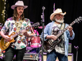 Duane and Dickey Betts playing guitars on stage