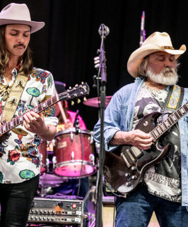 Duane and Dickey Betts playing guitars on stage