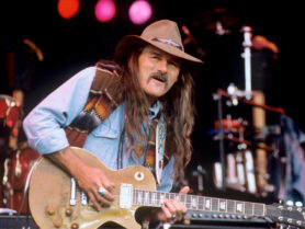 Dickey Betts plays his guitar on stage