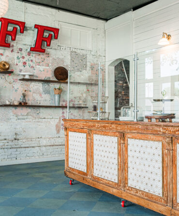 A white interior with a large red FF on the wall near a bakery counter.