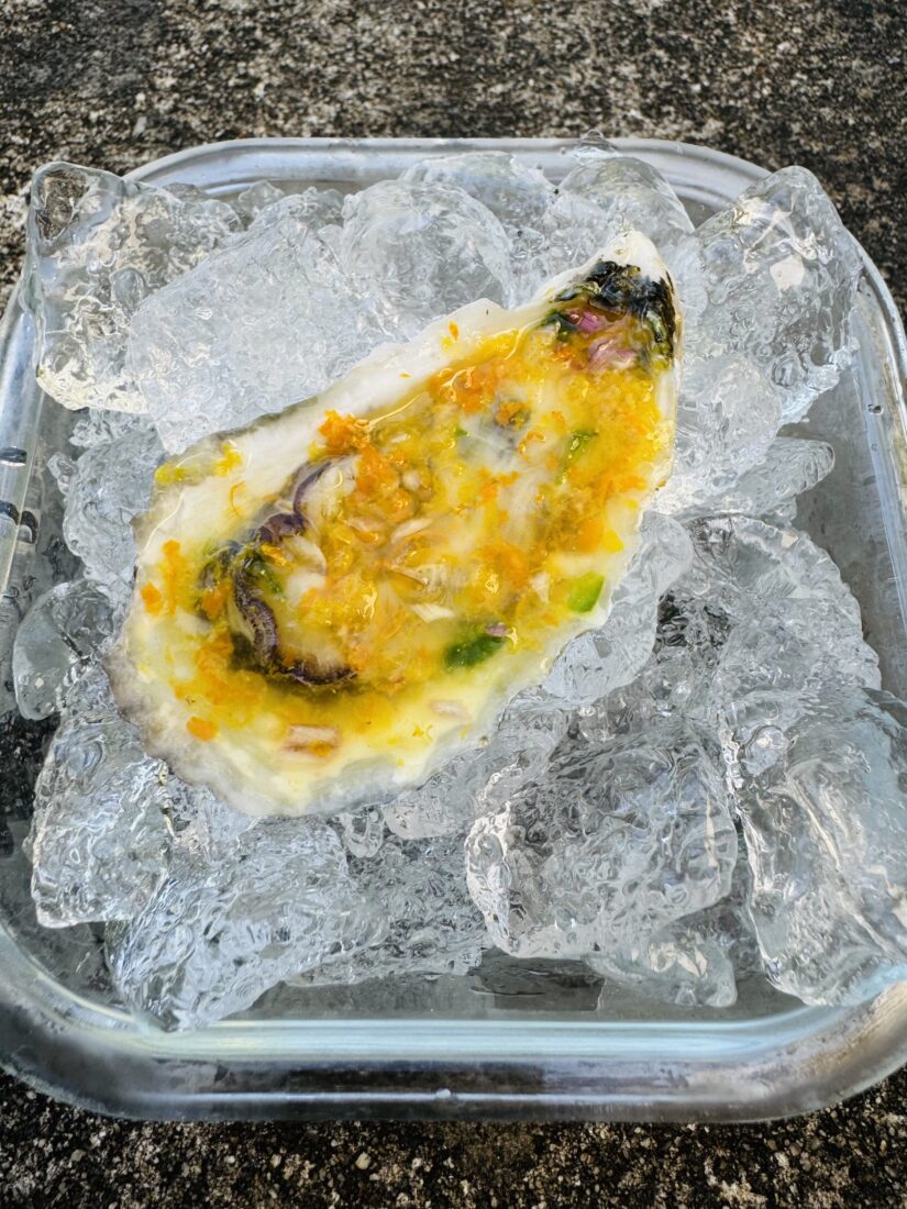 An oyster with orange dressing