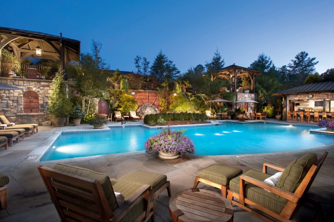 a pool at duck with lounge chairs at a resort