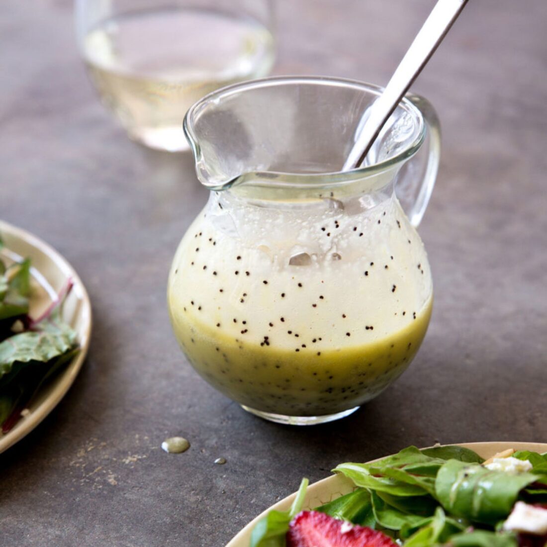 A small pitcher of salad dressing