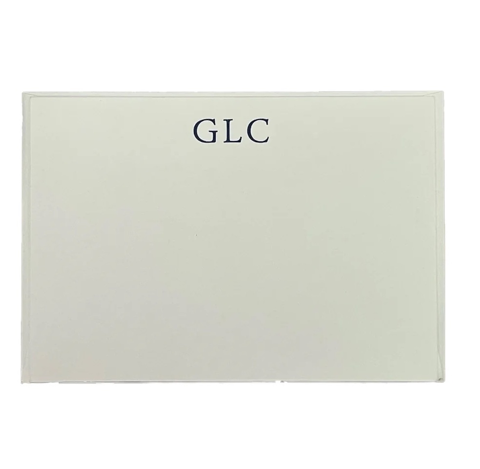 A green stationary card with initials