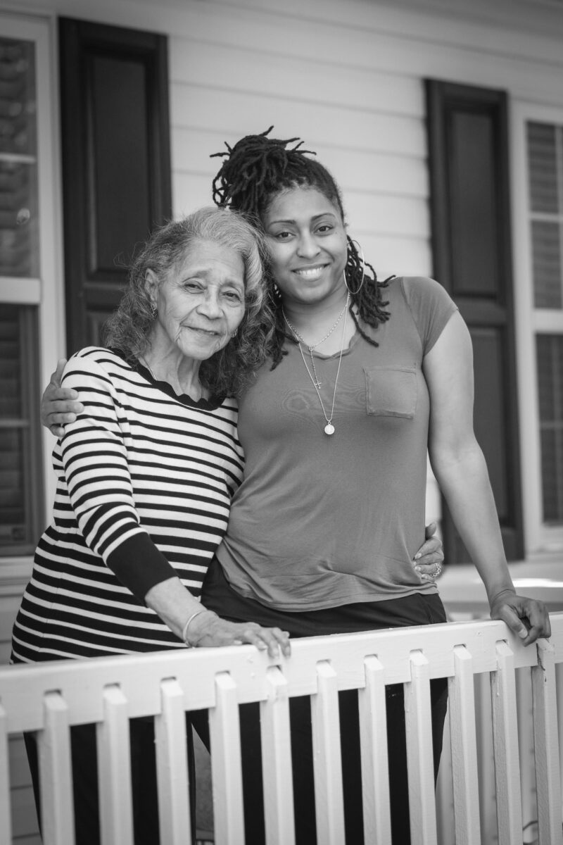 A portrait of two women on a porch