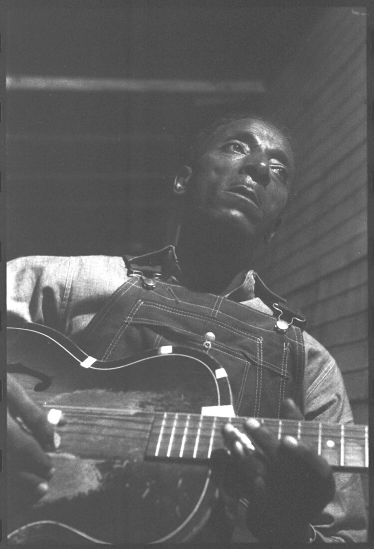 A man holds a guitar