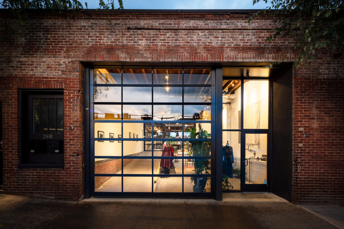 A brick store front with large glass window.