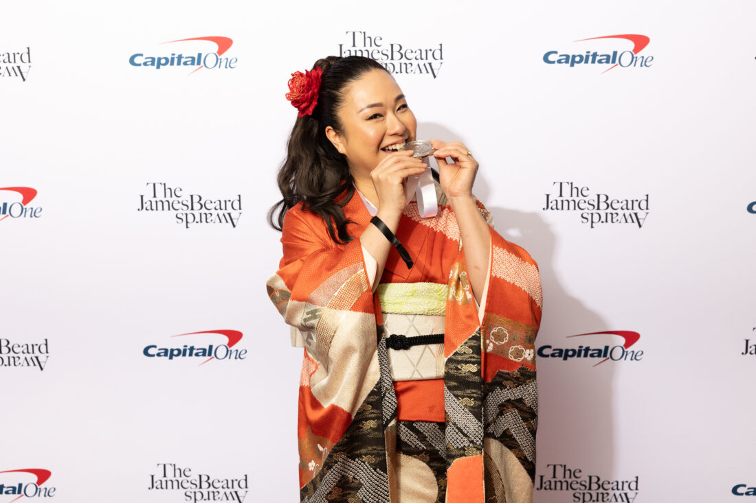 A woman poses with a medal