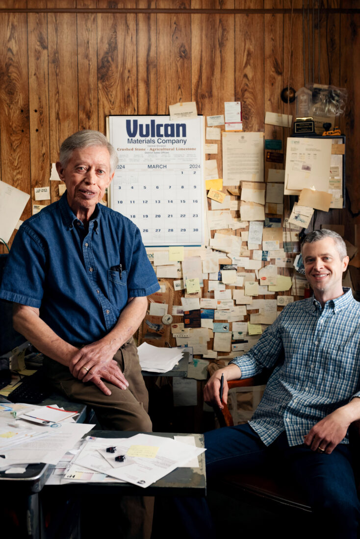 Two men sit in an office